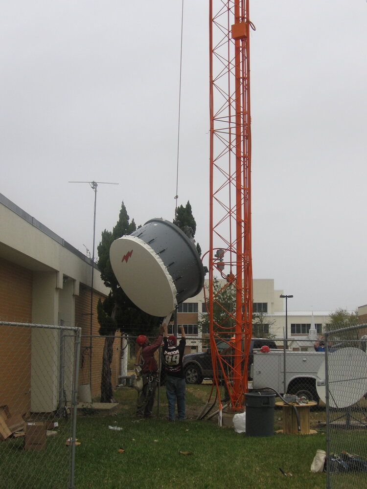 Microwave dish and tower at an installation site